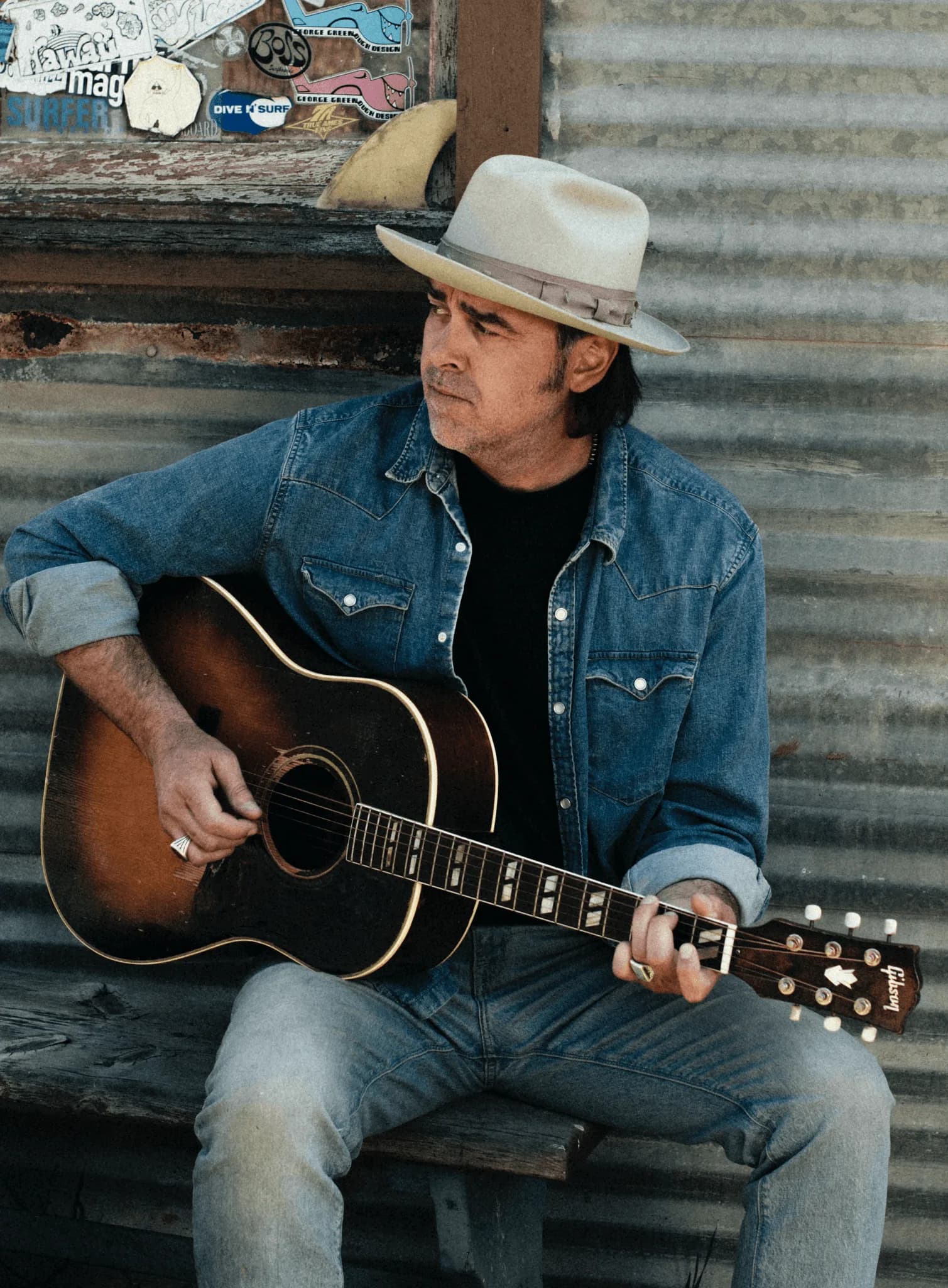 Musician with acoustic guitar, denim on denim