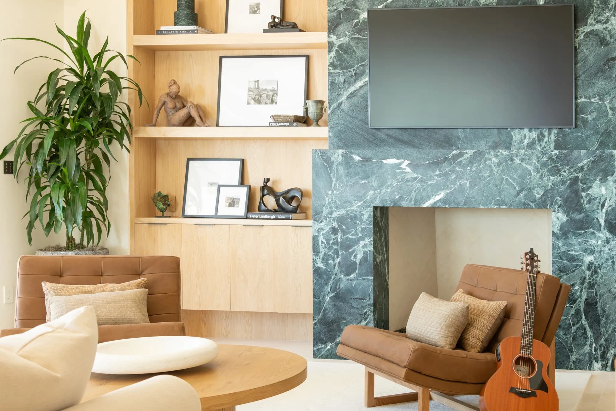 Living room with marble fireplace and warm wood