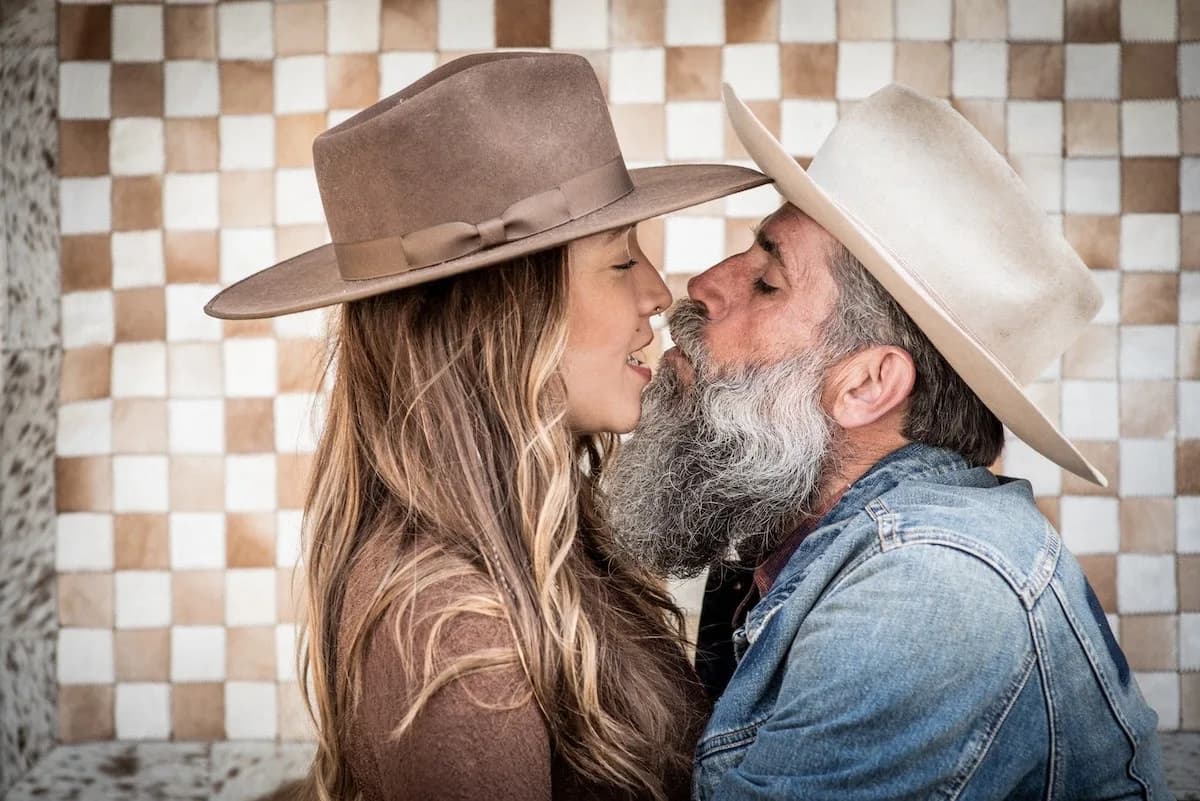 Western couple in felt hats, checkered backdrop
