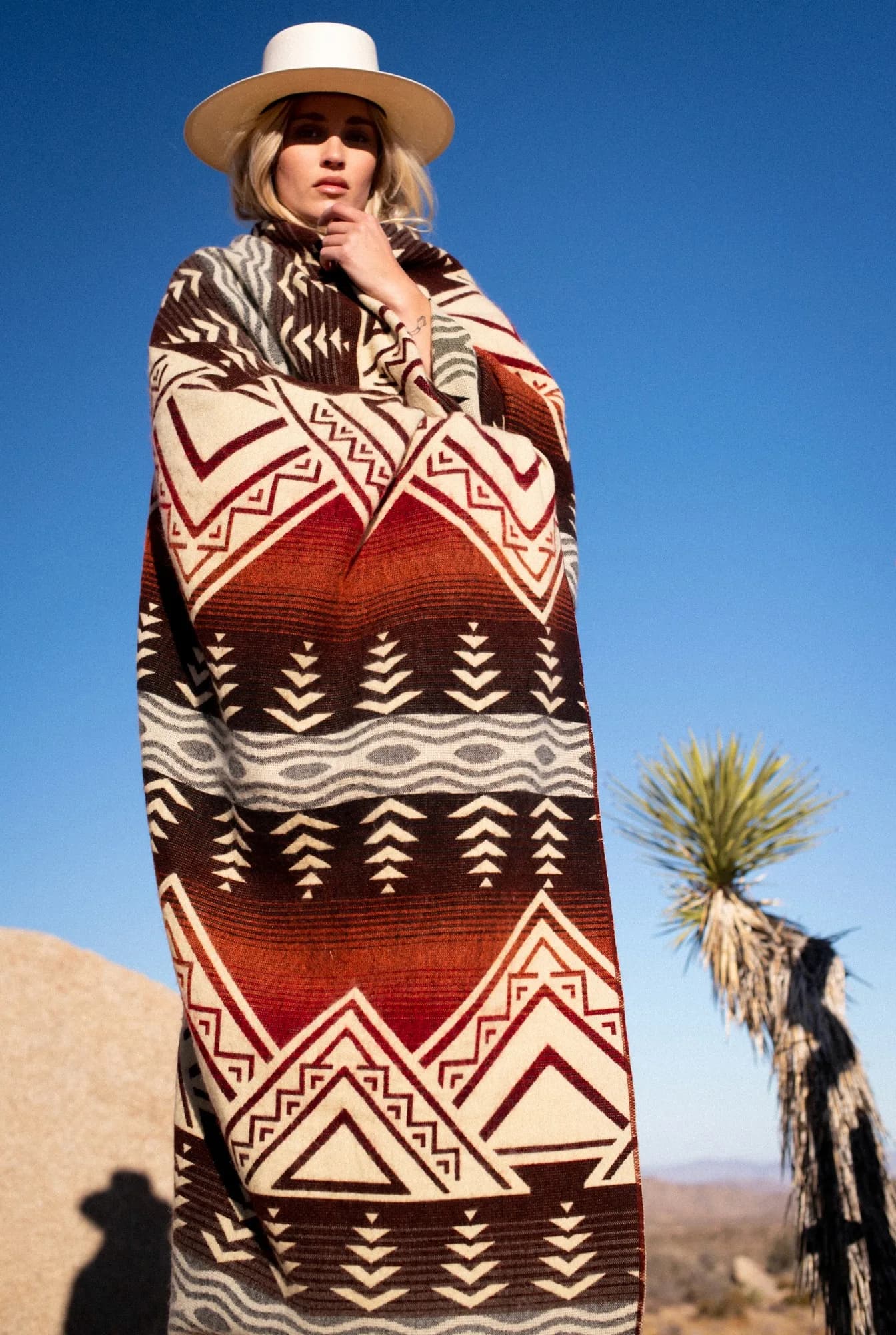 Model wrapped in a southwestern blanket in the high desert