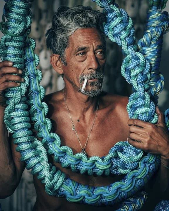 Elder fisherman with blue rope coils